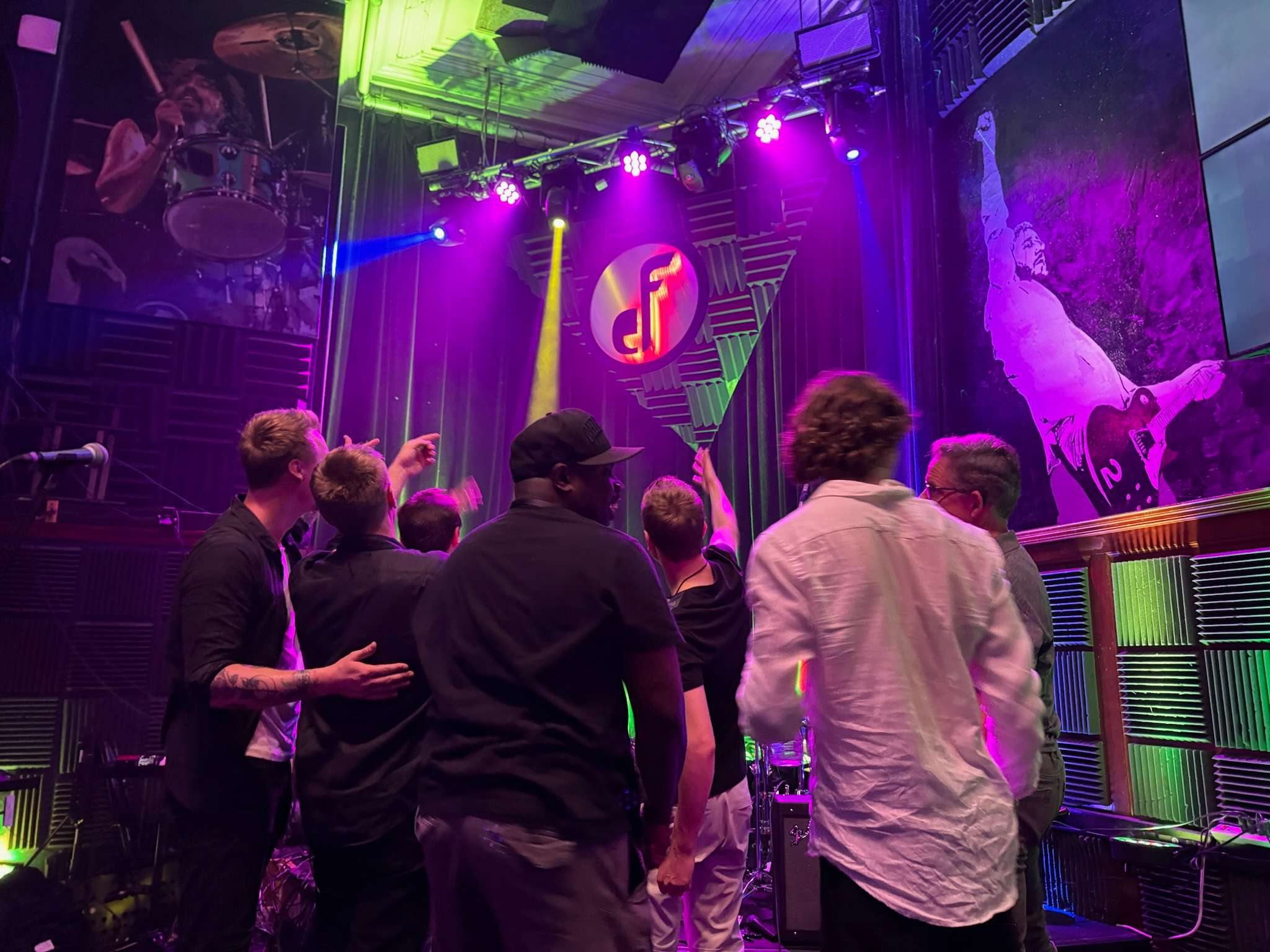 Crowd watching performance at Even Flow with purple stage lighting