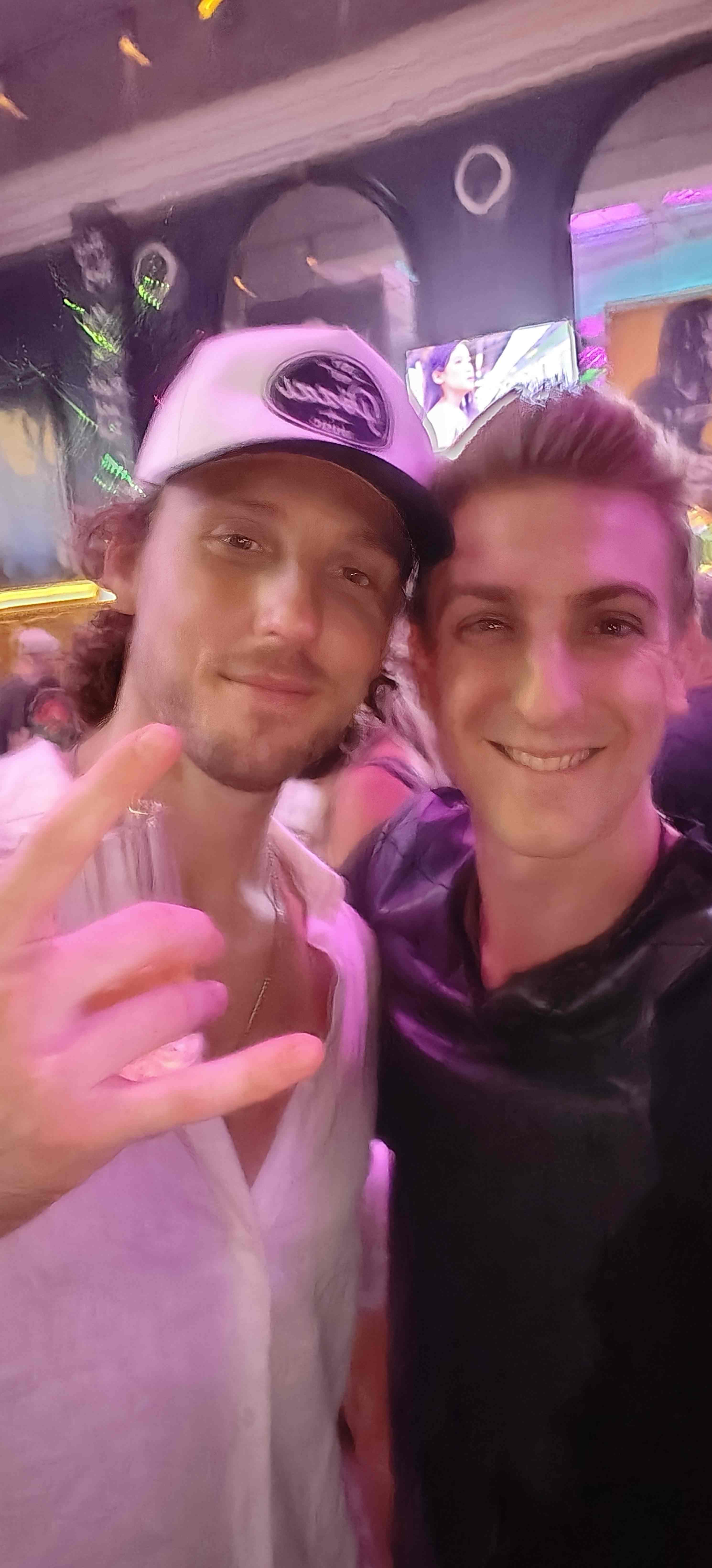 Selfie of two people at Even Flow with colorful stage lighting