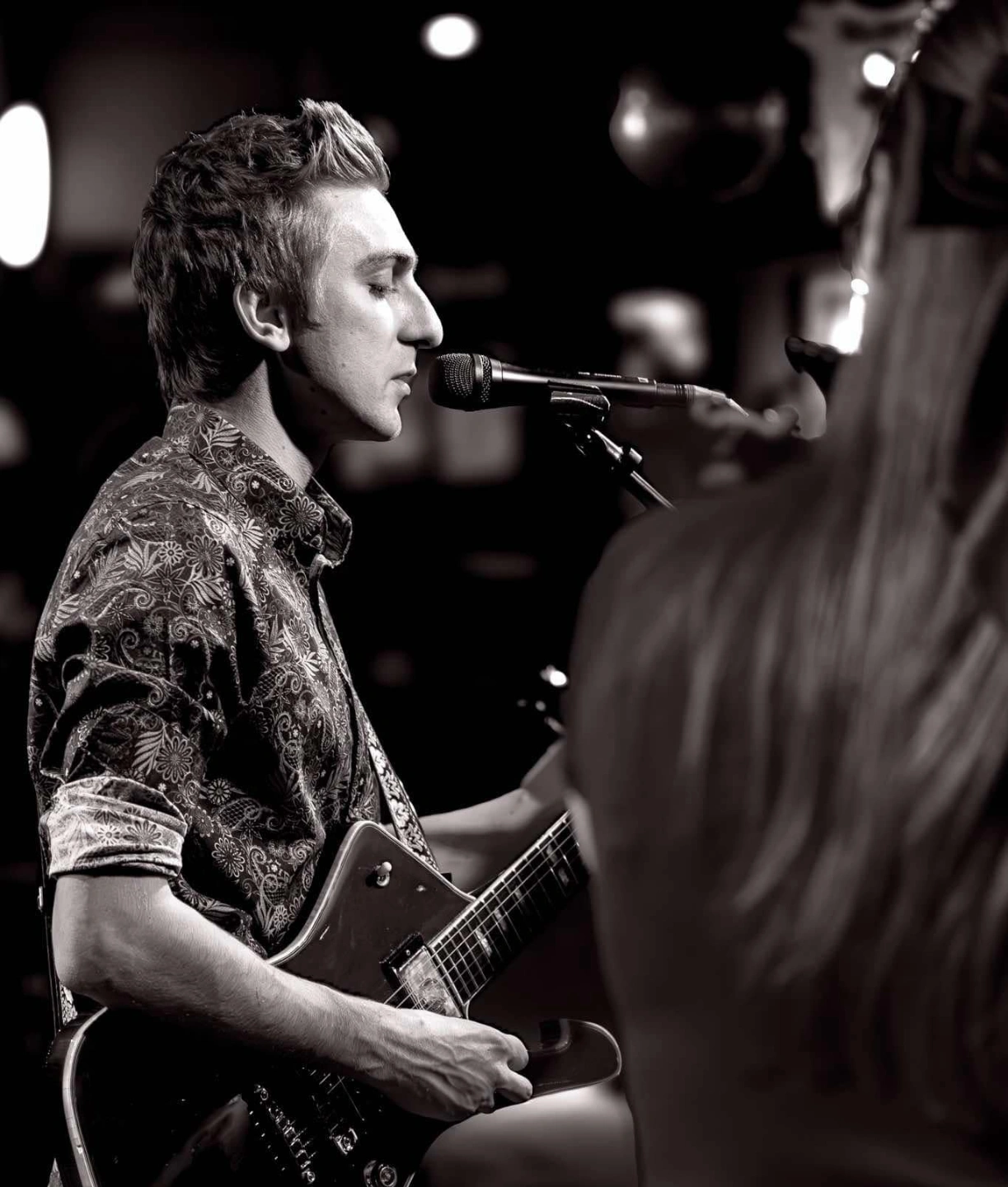 Black and white portrait of August James performing