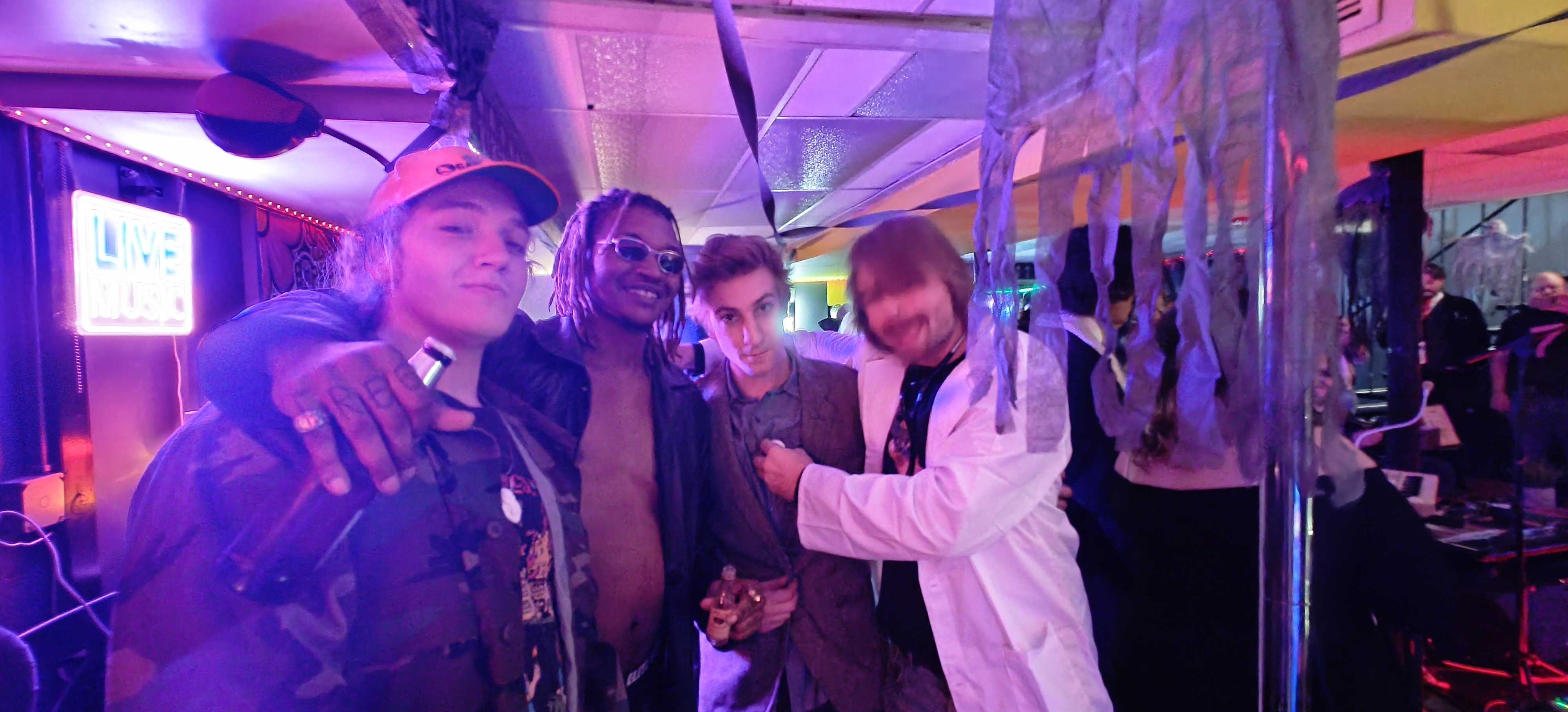 Group photo with friends in venue with purple neon lighting