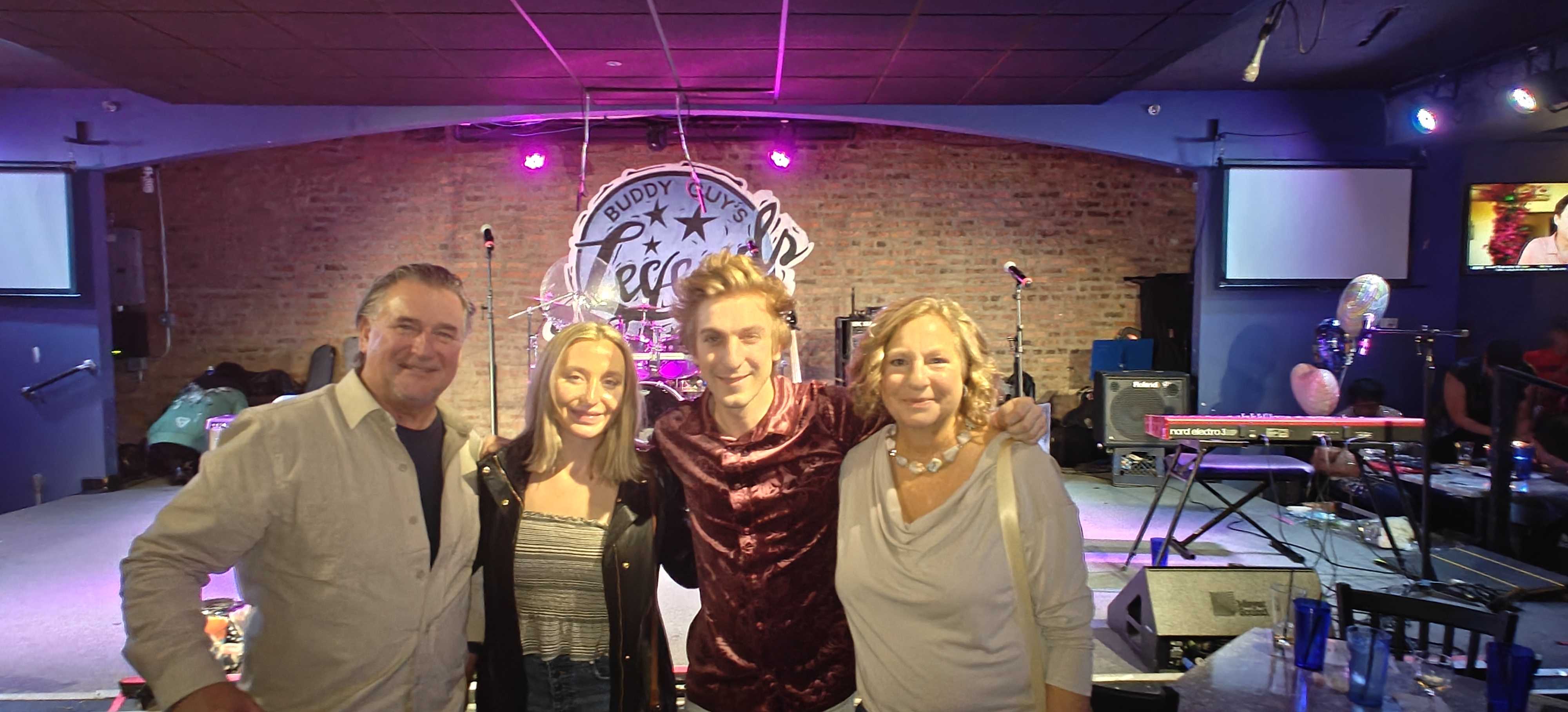 Group photo at Buddy Guy's Legends with friends on stage